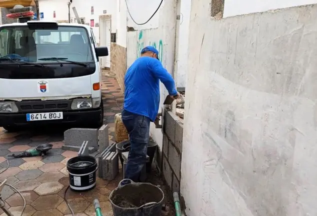 Uno de los operarios del Ayuntamiento tapiando el inmueble.