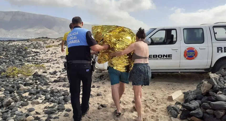 Momento en el que uno de los agentes de la Policía Local acompaña al bañista para su traslado al hospital