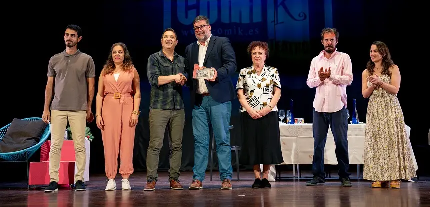 Isidro Pérez realizando la entrega de un reconocimiento a los artistas de una de las obras realizadas.