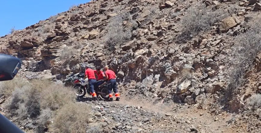 Los bomberos recogiendo la moto de montaña