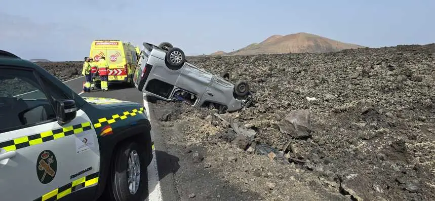 Guardia Civil y ambulancia del SUC junto al vehículo volcado.