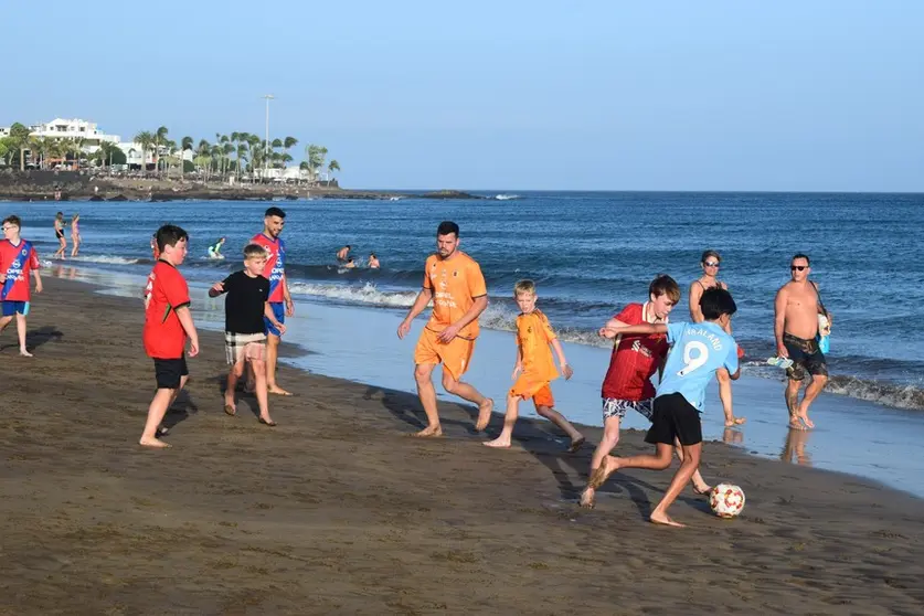 Imagen de archivo de los jugadores de la UD Lanzarote junto a los niños en Playa Grande.