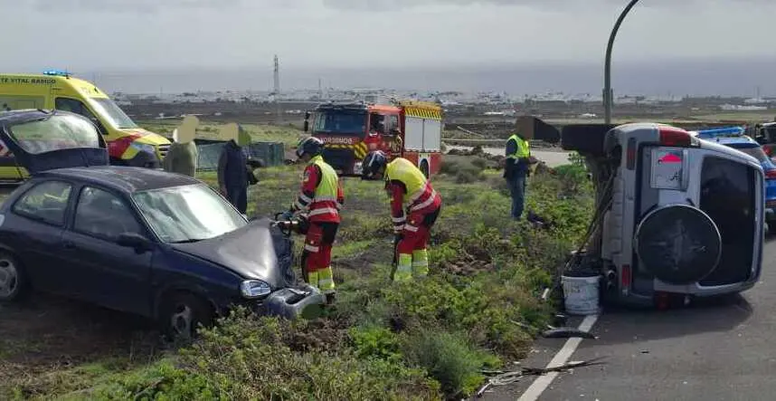 Bomberos y personal del SUC junto a los veh&iacute;culos implicados en el choque.