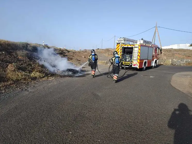 Bomberos sofocando el incendio.