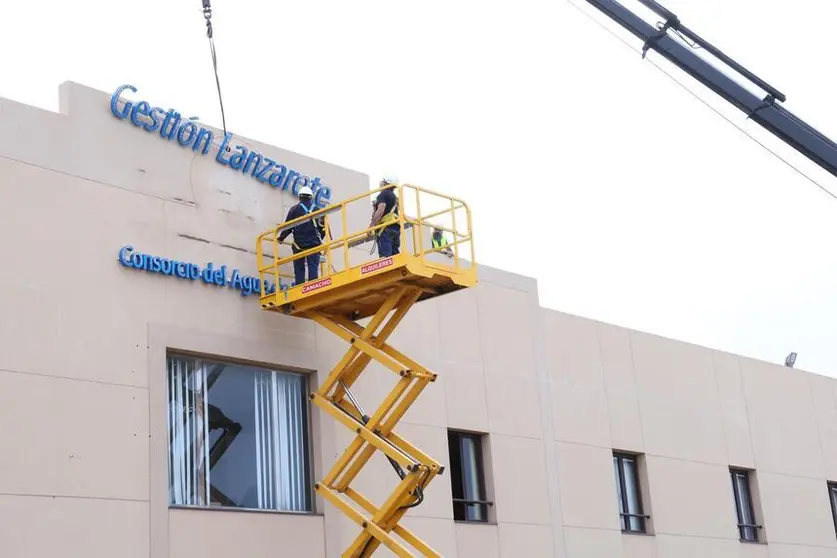 Operarios retirando el rotulado de Canal Gesti&oacute;n.