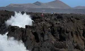 Personas en la zona de los Hervideros durante el fuerte oleaje.