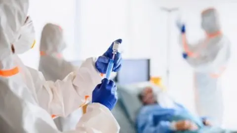 Doctors looking after infected patients in hospital, coronavirus concept.