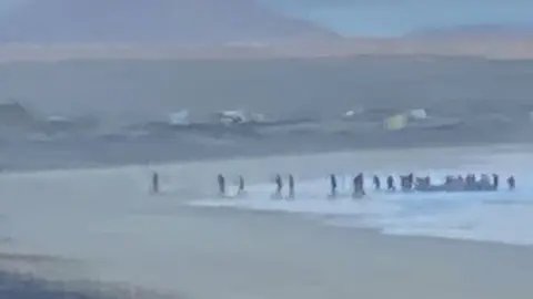 Imagen de la gente desembarcando en la playa de Famara este lunes.