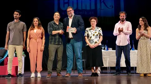 Isidro Pérez realizando la entrega de un reconocimiento a los artistas de una de las obras realizadas.