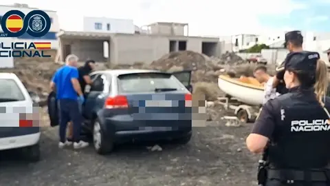 Policía Nacional realizando al detención y revisando un vehículo.