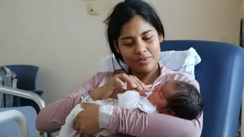 Madre junto a uno de los ni&ntilde;os nacidos en 2025.