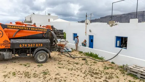 Olivia Duque junto a una vecina durante las labores de vaciado de Pozos Negros en La Graciosa.