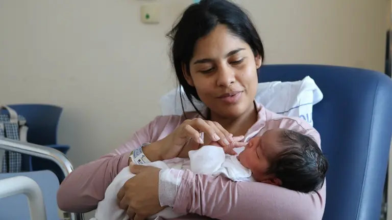 Madre junto a uno de los ni&ntilde;os nacidos en 2025.